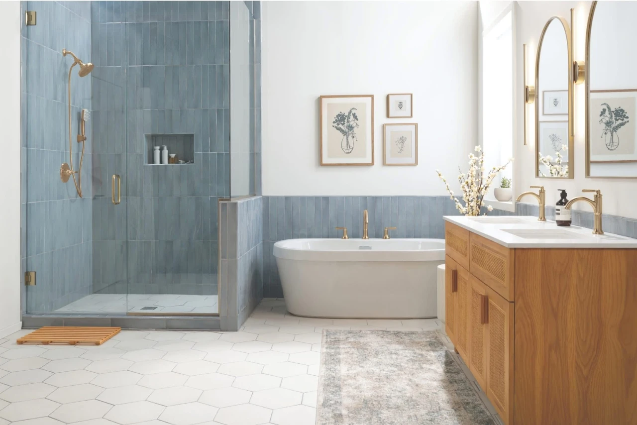 A modern master bathroom featuring vertical blue tile walling, a glass walk-in enclosure with brushed gold fixtures, and custom bathroom remodel ideas for showers alongside a freestanding bathtub.