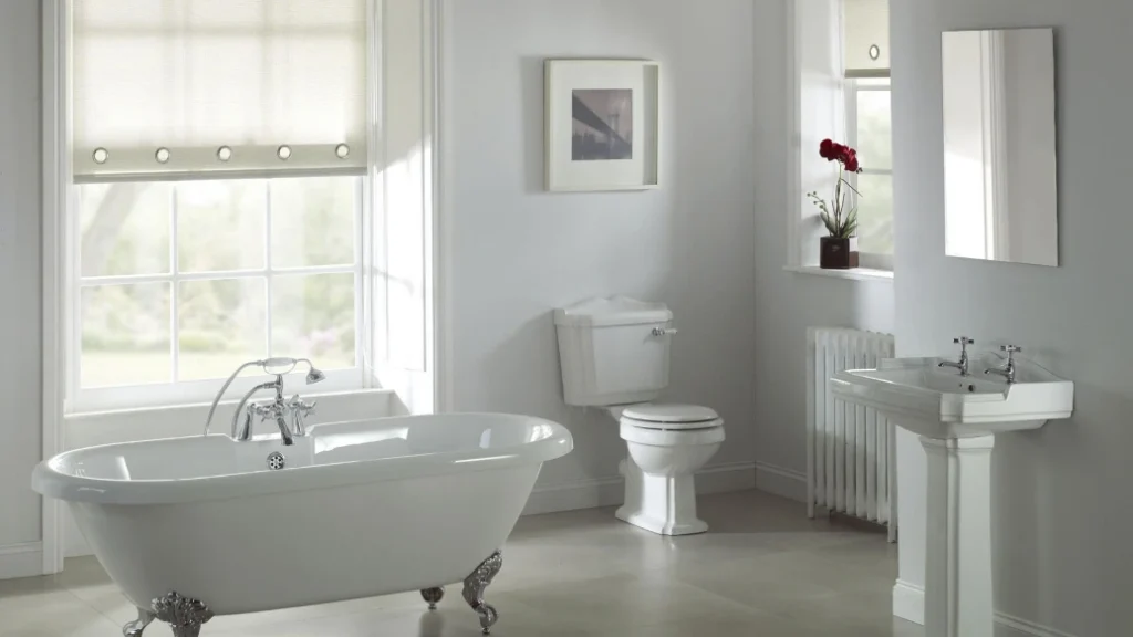 Remodeled bathroom with freestanding bathtub and pedestal sink