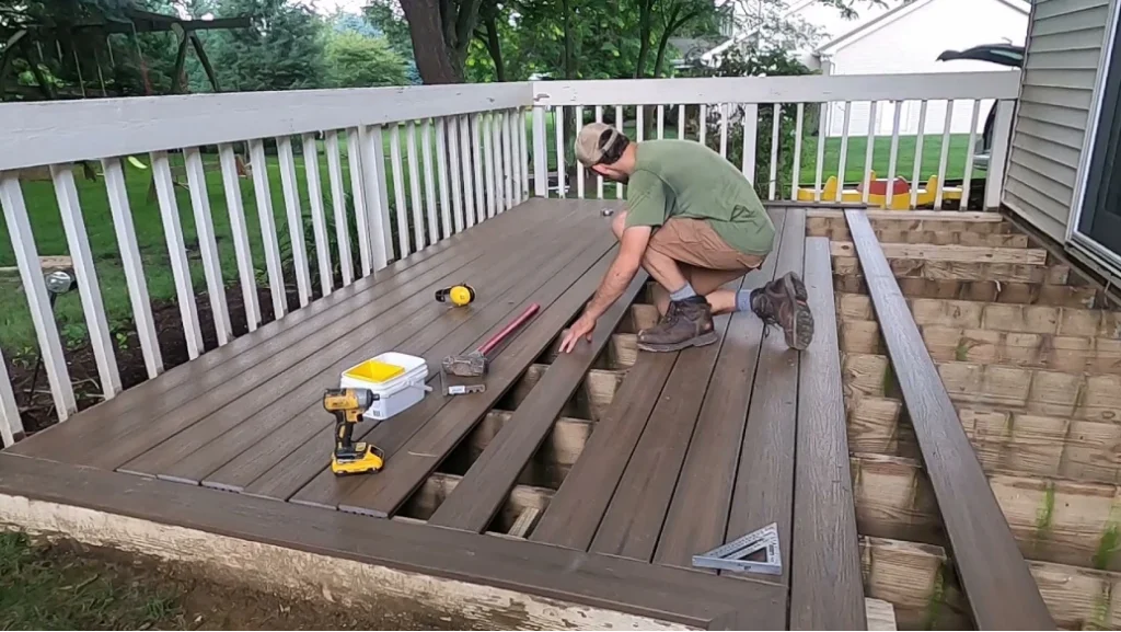 Contractor installing composite decking on a backyard deck